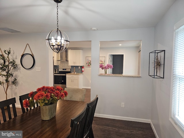 dining space featuring a wealth of natural light, a chandelier, and dark wood-type flooring