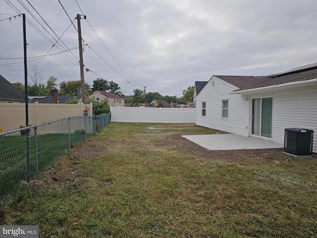 view of yard with cooling unit and a patio