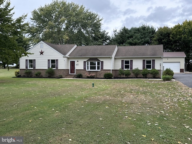 ranch-style house with a garage and a front lawn