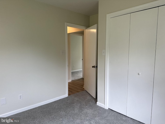 unfurnished bedroom with a closet and carpet flooring