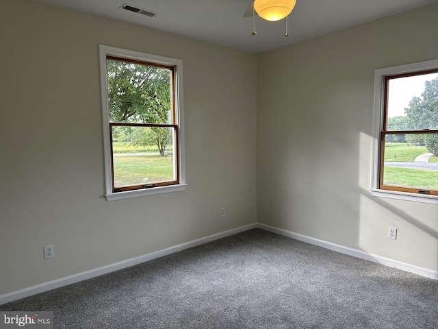 spare room with a healthy amount of sunlight, carpet, and ceiling fan