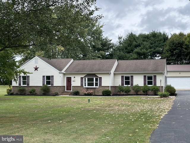 ranch-style home with a garage and a front yard