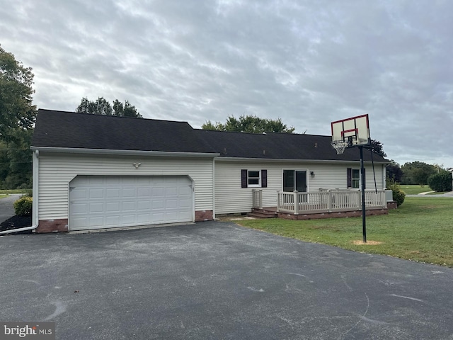 view of front of house with a garage, a deck, and a front lawn