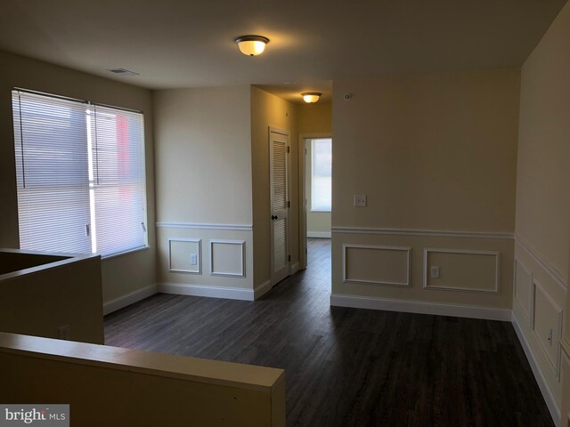 empty room with dark hardwood / wood-style floors