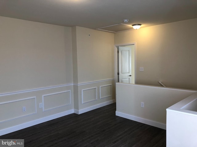 unfurnished room featuring dark wood-type flooring