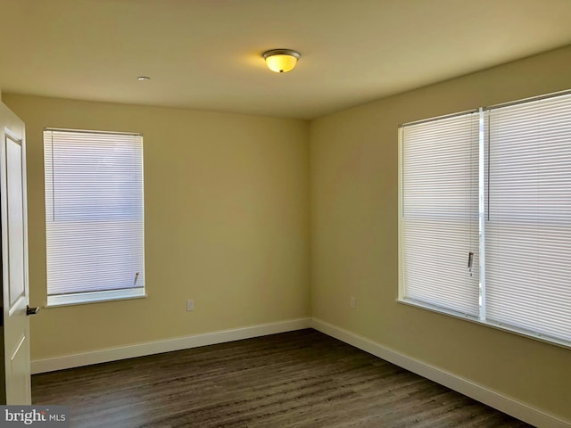 spare room featuring dark wood-type flooring