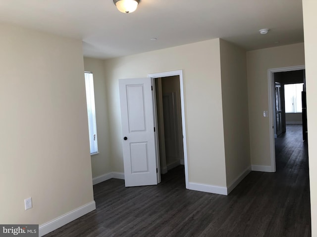 unfurnished bedroom featuring dark hardwood / wood-style flooring