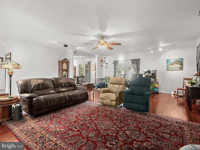 living room featuring hardwood / wood-style floors, ceiling fan, and rail lighting