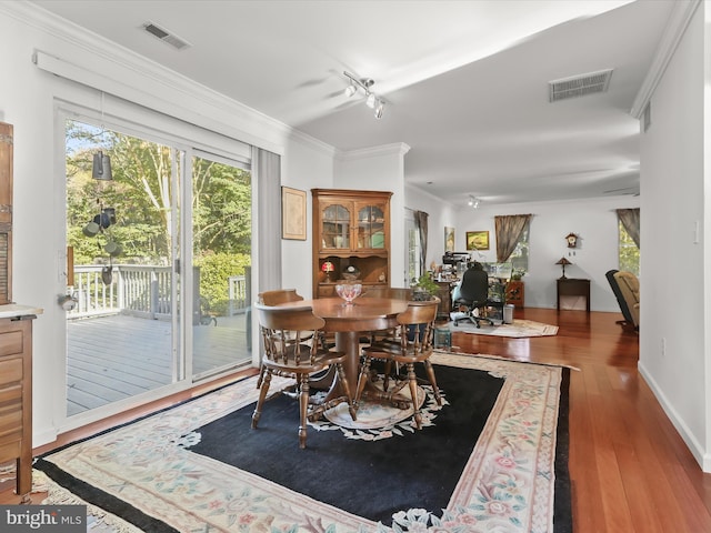 dining area featuring crown molding and dark hardwood / wood-style flooring