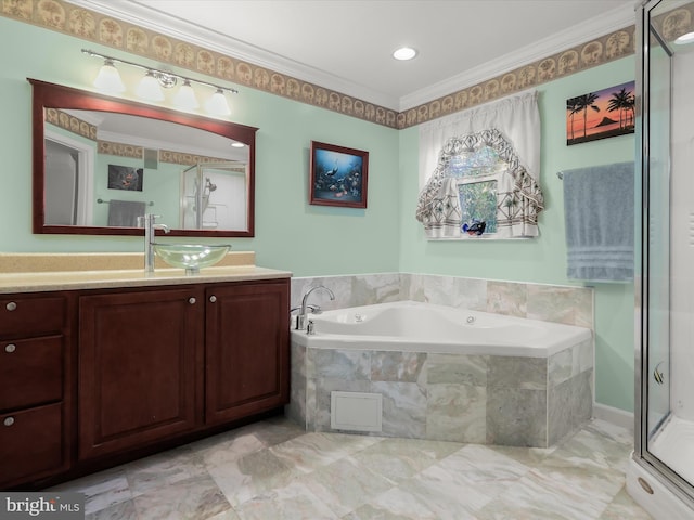 bathroom featuring vanity, ornamental molding, and separate shower and tub