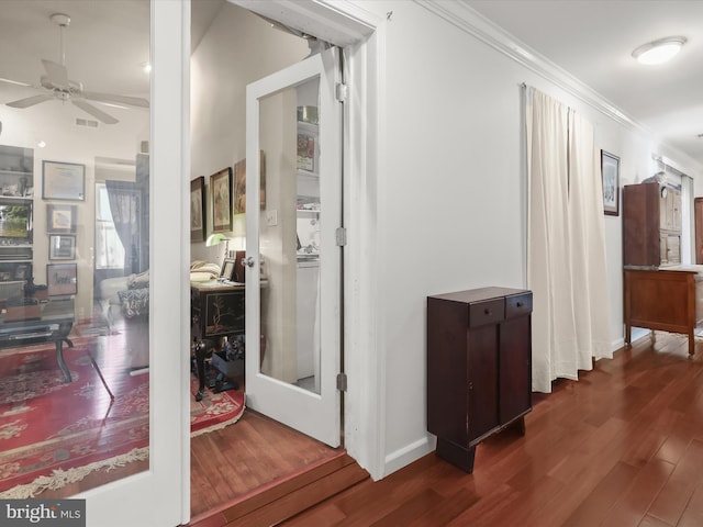 corridor with ornamental molding and dark hardwood / wood-style floors