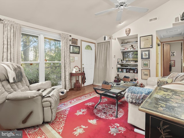 living room featuring vaulted ceiling, hardwood / wood-style flooring, and ceiling fan