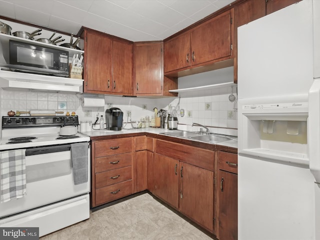 kitchen with sink, tasteful backsplash, white appliances, and extractor fan