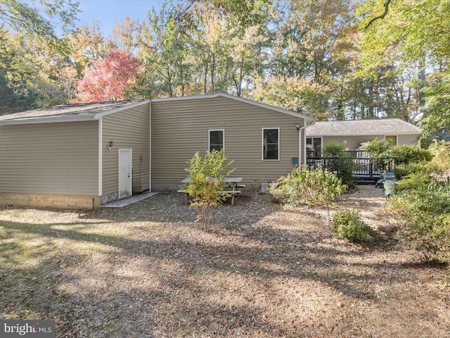 rear view of property with a wooden deck