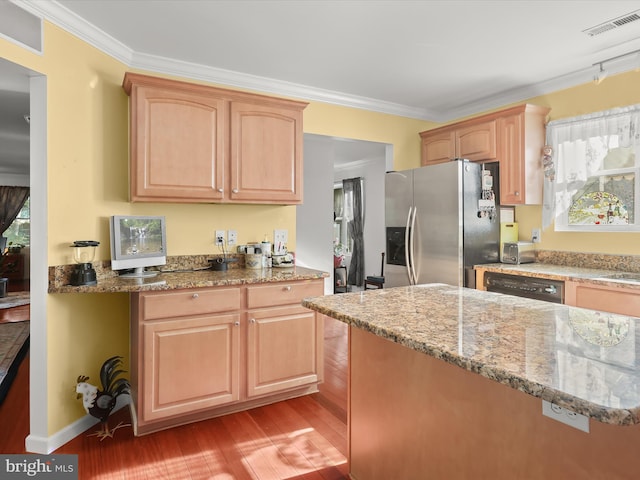 kitchen with ornamental molding, stainless steel fridge, a healthy amount of sunlight, and light wood-type flooring