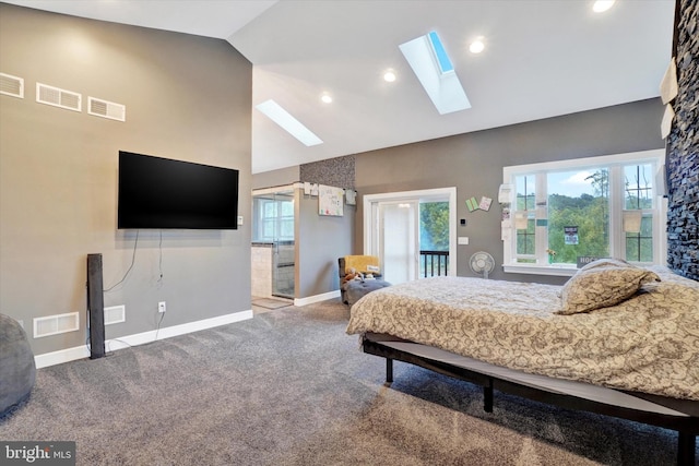 carpeted bedroom featuring a skylight and high vaulted ceiling