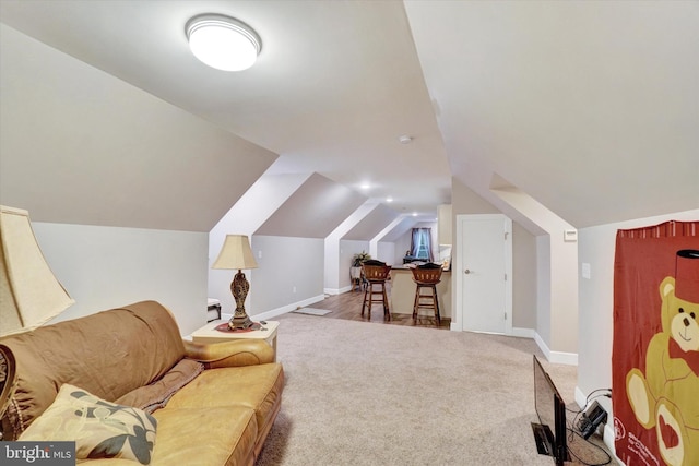 sitting room with vaulted ceiling and carpet