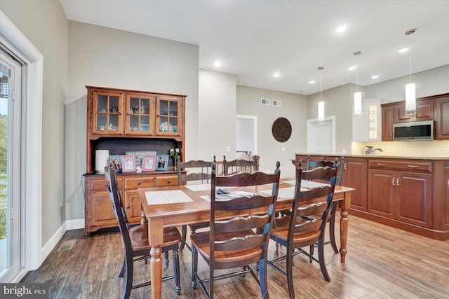 dining area with light hardwood / wood-style flooring and plenty of natural light