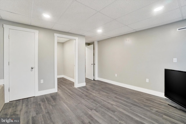 basement featuring wood-type flooring and a paneled ceiling