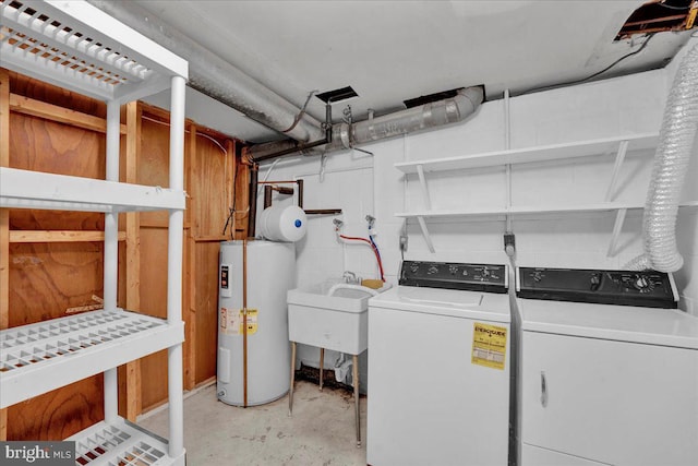 laundry room featuring washer and clothes dryer, water heater, and sink