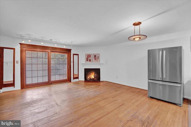 unfurnished living room with light hardwood / wood-style flooring