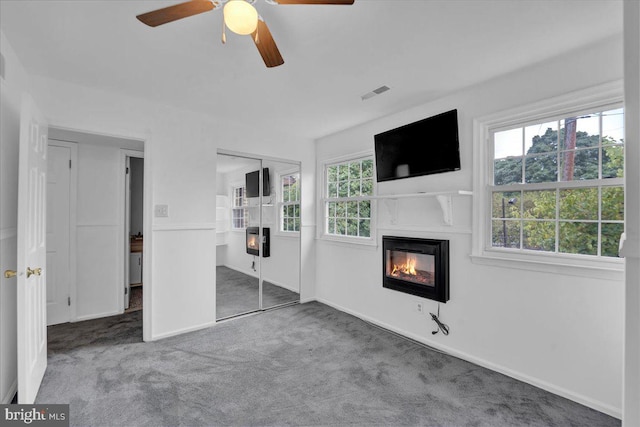 unfurnished bedroom featuring carpet floors, ceiling fan, and a closet