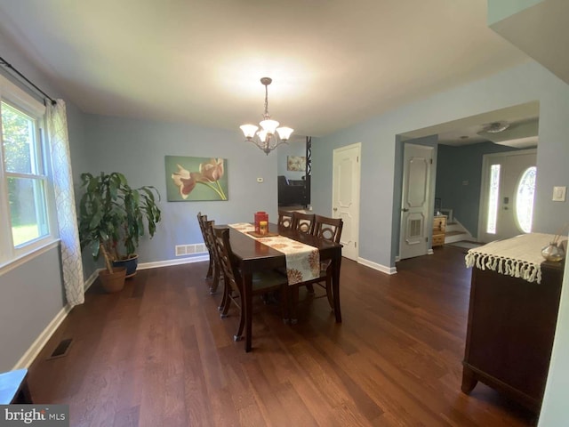 dining room featuring an inviting chandelier and dark hardwood / wood-style floors