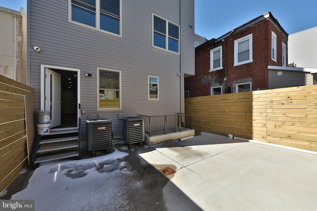 rear view of house featuring a patio and central AC