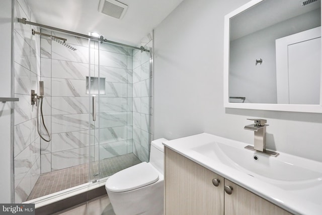 bathroom with vanity, toilet, and an enclosed shower