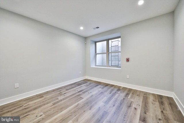 unfurnished room with light hardwood / wood-style floors