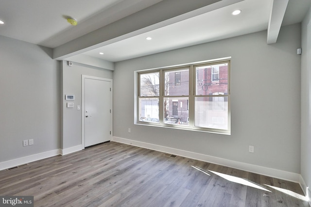 entrance foyer featuring light hardwood / wood-style flooring and beamed ceiling