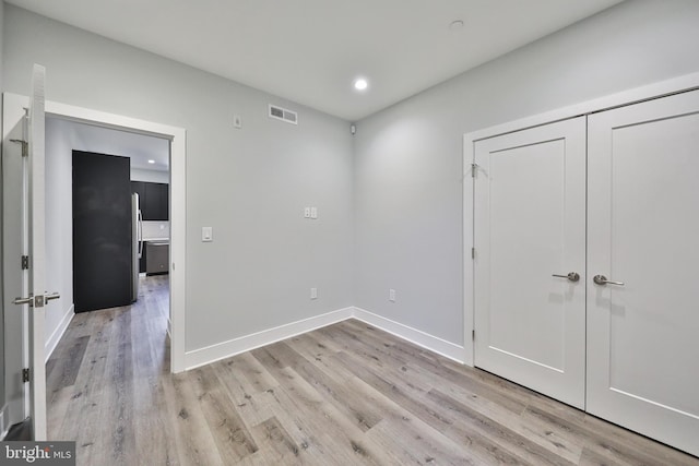 spare room with light hardwood / wood-style floors