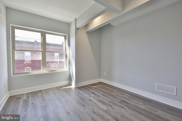 spare room featuring light hardwood / wood-style flooring