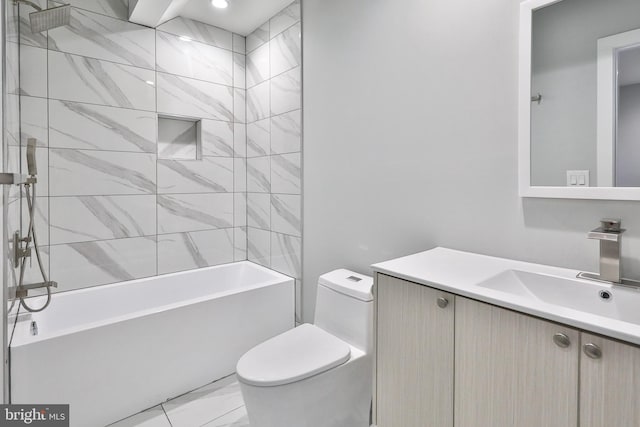 full bathroom featuring tiled shower / bath, vanity, and toilet