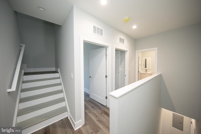 stairs with hardwood / wood-style flooring