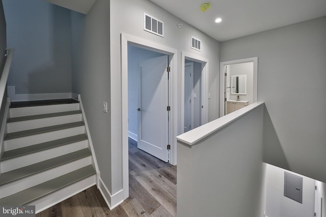 stairs featuring hardwood / wood-style floors