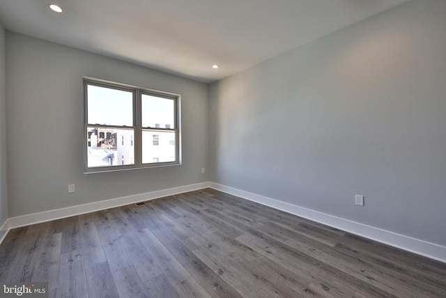 unfurnished room with hardwood / wood-style floors