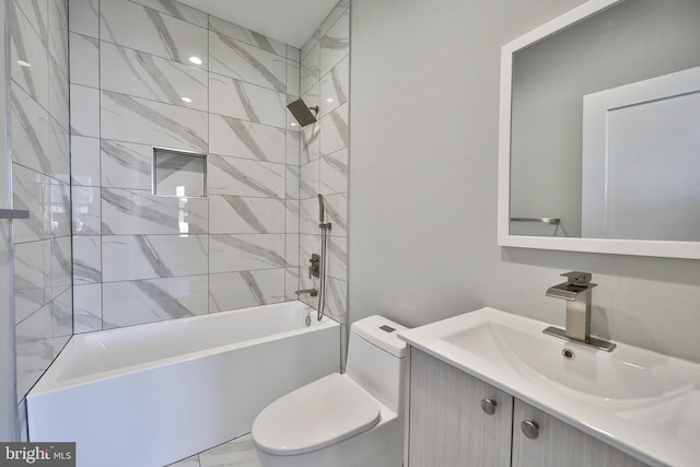 full bathroom featuring tiled shower / bath combo, vanity, and toilet