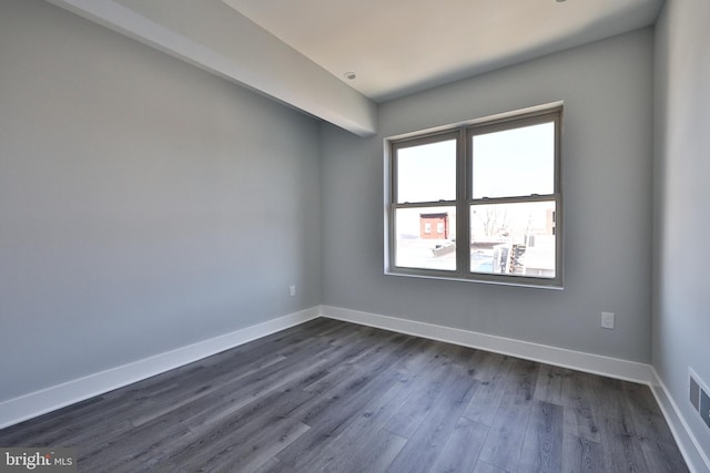 unfurnished room featuring dark wood-type flooring