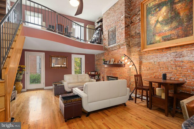 606 N 2nd St, Philadelphia, PA 19123 - living area with a ceiling fan, hardwood / wood-style flooring, a fireplace, stairway, and a towering ceiling