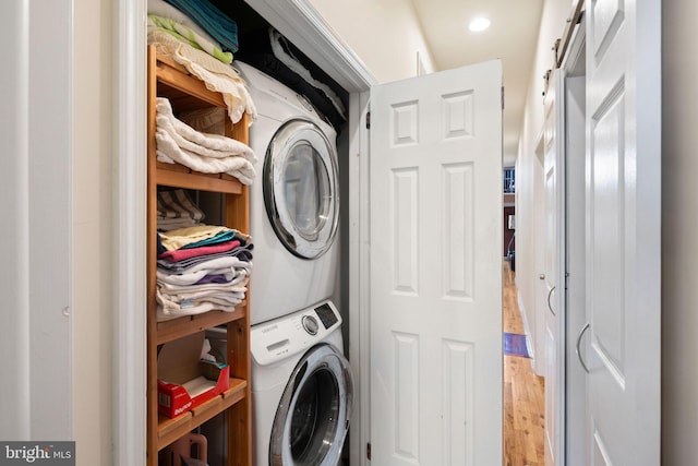 606 N 2nd St, Philadelphia, PA 19123 - laundry room featuring stacked washing maching and dryer, light wood-type flooring, and laundry area