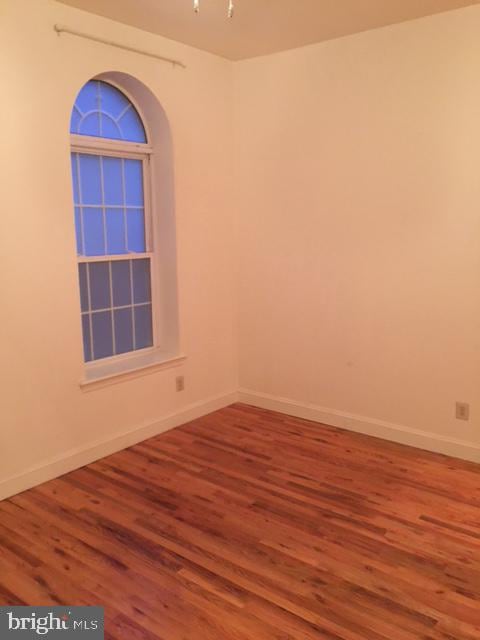 unfurnished room featuring hardwood / wood-style floors