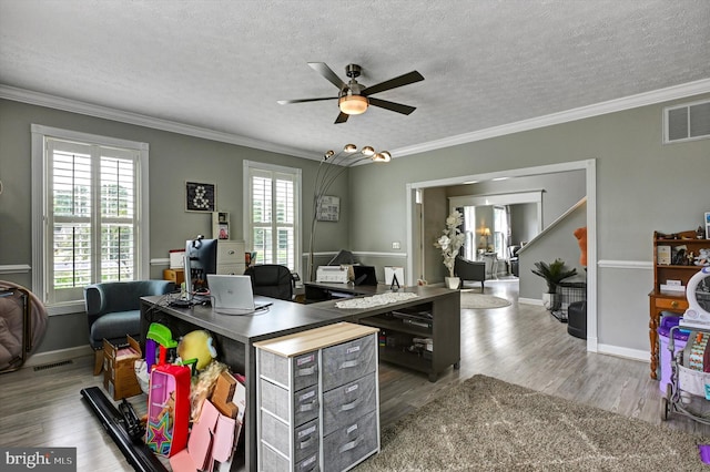 home office featuring hardwood / wood-style flooring, a healthy amount of sunlight, ornamental molding, and a textured ceiling