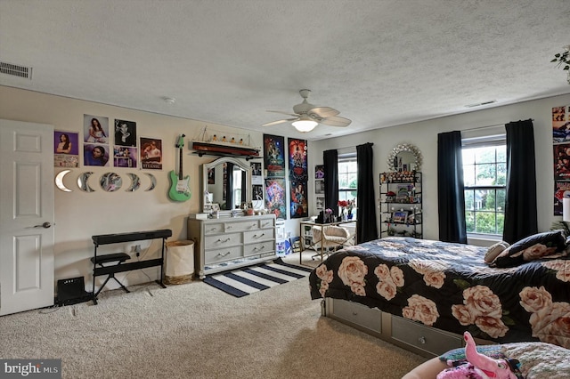 bedroom with light carpet, a textured ceiling, and ceiling fan