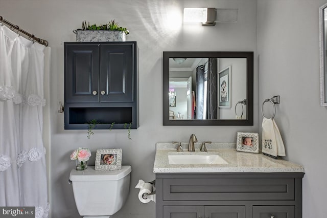 bathroom featuring toilet and vanity