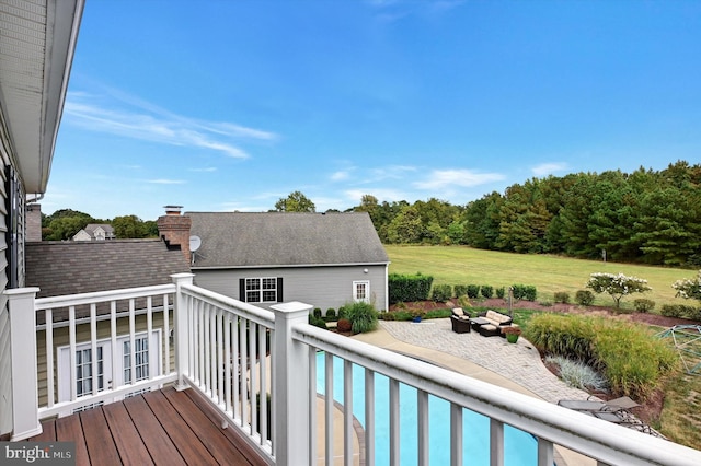 wooden terrace with a patio and a swimming pool