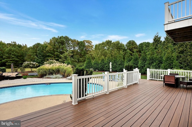 view of pool with a wooden deck