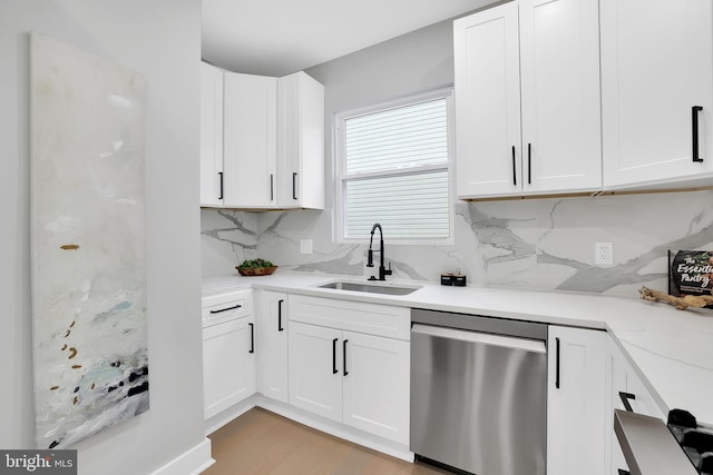 kitchen featuring white cabinets, dishwasher, sink, and tasteful backsplash