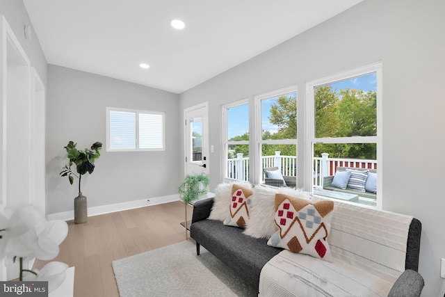 living room with vaulted ceiling and hardwood / wood-style floors