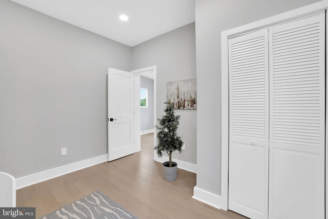 corridor with light hardwood / wood-style flooring